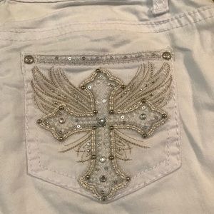 White shorts with sequined cross back pockets.